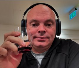 Stuart Bingham in headphones with a drink
